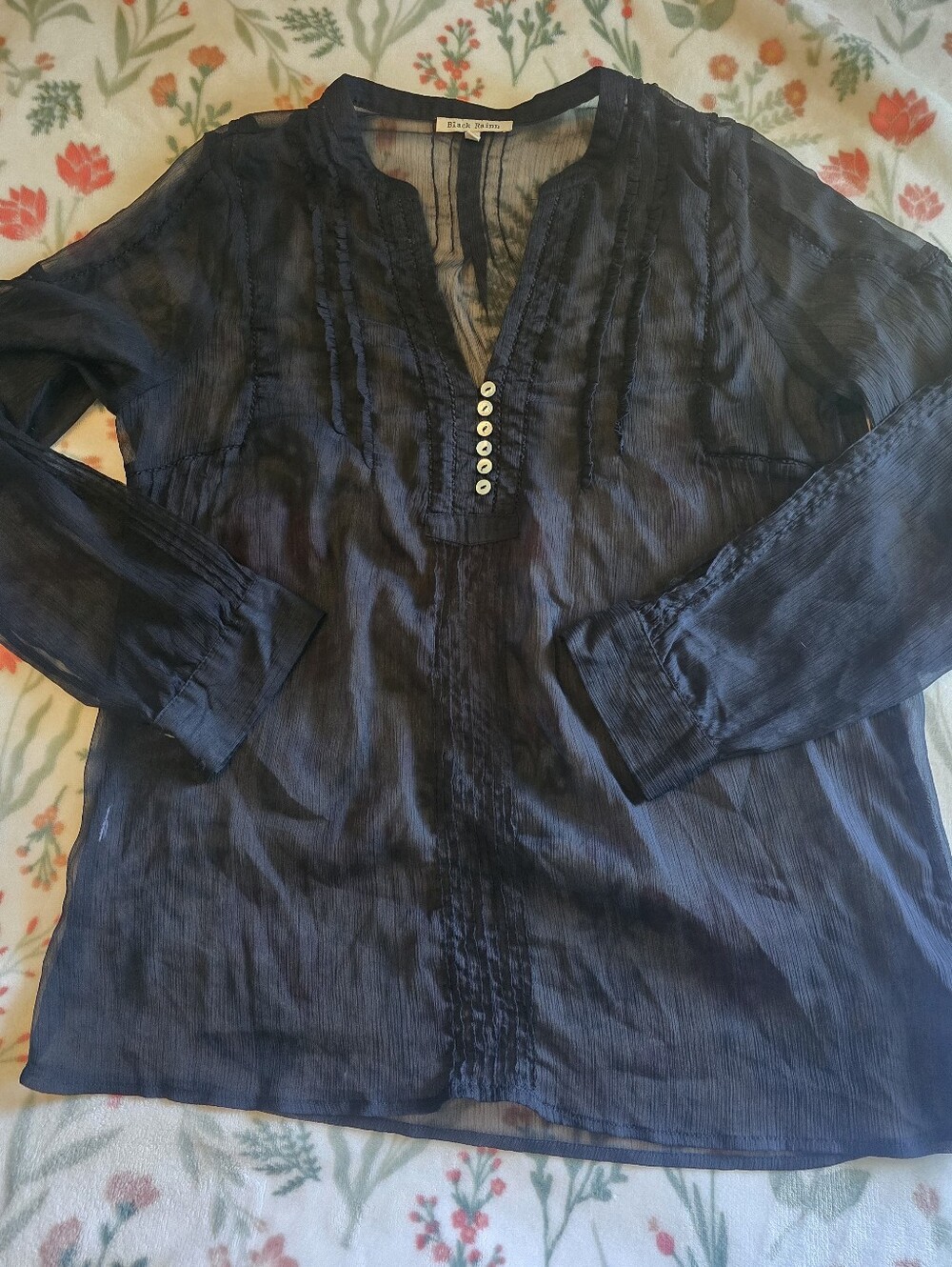 Sheer black blouse is from the brand Black Rainn.